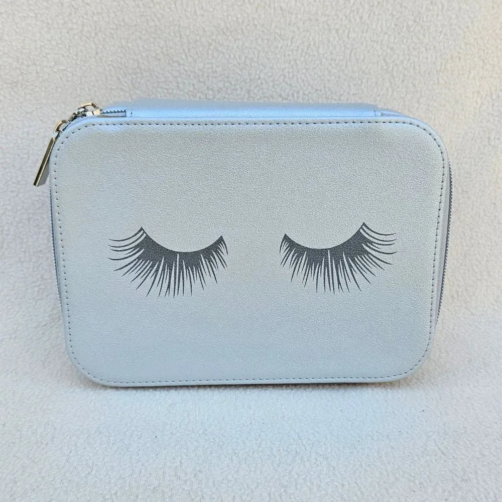 Neiman Marcus Silver Cosmetic Case with Eyelashes on the Front